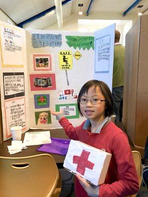 My daughter demonstrates her Wonder Works Project, How to Keep Kids Safe on the Playground.