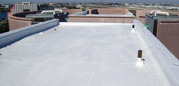 Flat rubber roof with silver coating.