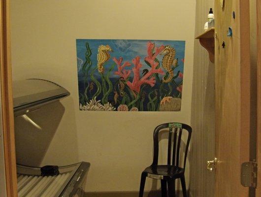 Each of the tanning rooms has a hand painted mural