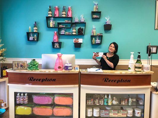 Reception desk with sign-in sheet, products available for purchase & lotion for clients to try out!