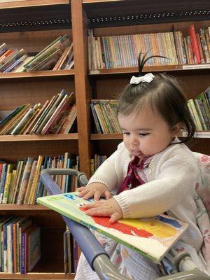 Baby reading her free book from goodwill