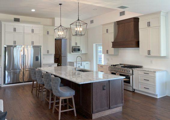 white kitchen with cherry wood island and quartzite counter-top