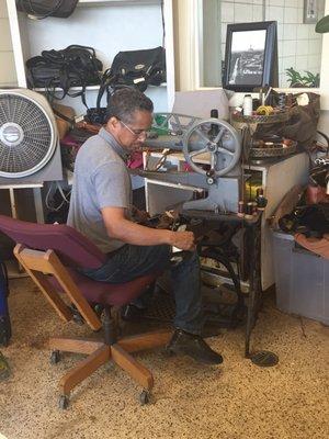 The man himself, Mr Ramos, hard at work repairing shoes.