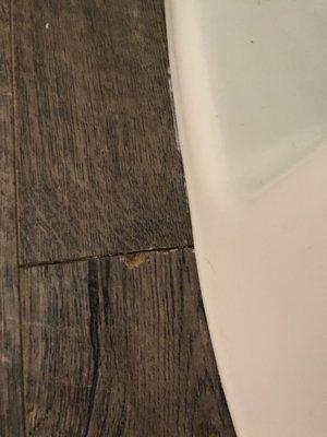 Chip in wood caused by plumber.