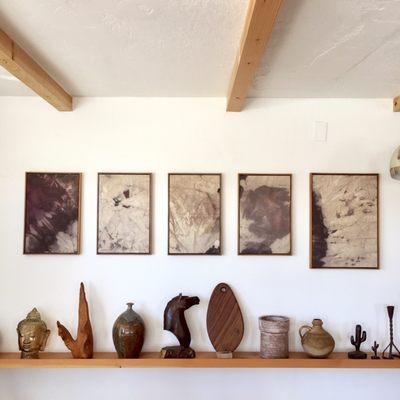 A rotating art gallery wall featuring local artists and found vintage objects and our serving boards.