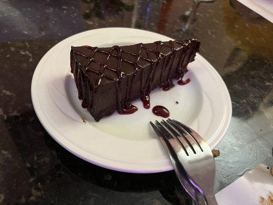 Slice of Chocolate Decadence Cake with raspberry sauce