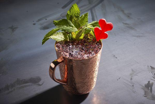 A specialty cocktail in a mule mug