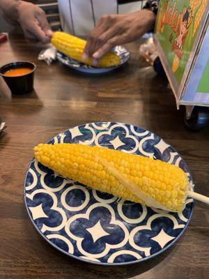 Corn is located inside the cart.