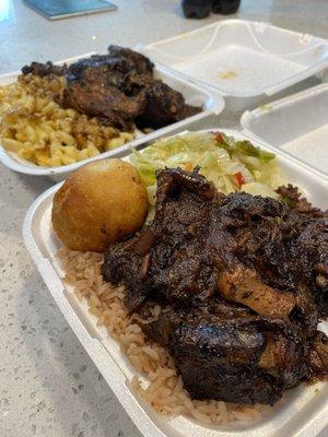 Oxtails with rice and peas in the front, jerk chicken with Mac and cheese in the back. Very fresh and hot