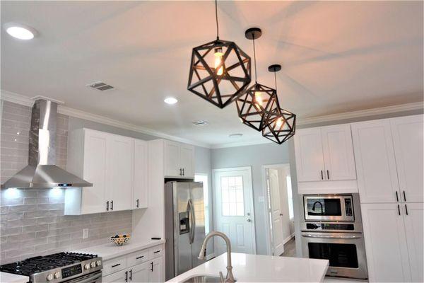 White kitchen design with black accent accessories.