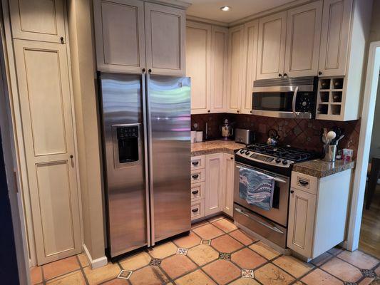 Before picture showing the horrible and old paint  job on the cabinets