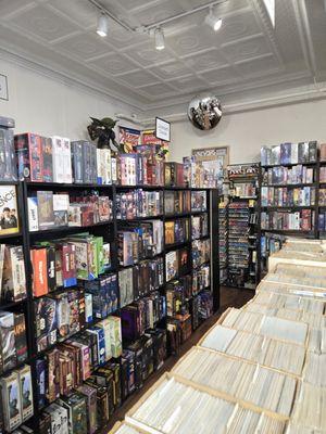 Comic book collections among games on shelves.