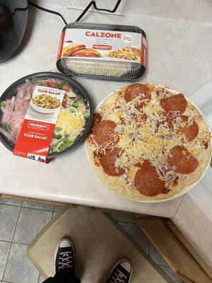 Pepperoni and onions pizza, pepperoni and cheese calzone and a chef salad.