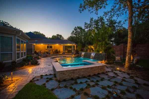 Perfectly secluded pool with a spa and water feature, complete with a raised and covered outdoor patio!