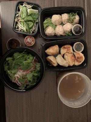 Beef pho (deconstructed), steam pork buns (top left-15 minute wait needed), pork pan fried (top middle)