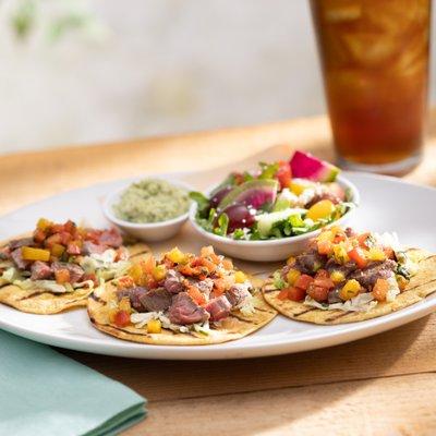 Wood-Grilled Steak Tacos—taco slaw, pico de gallo, cotija, avocado, lime