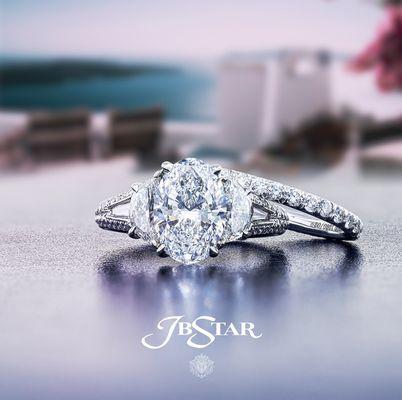 This dazzling diamond wedding set features a stunning GIA certified oval diamond center embraced by half moon from JB Star.