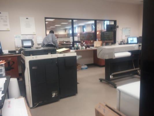 Inside the ground floor office. Library is beyond the back glass.