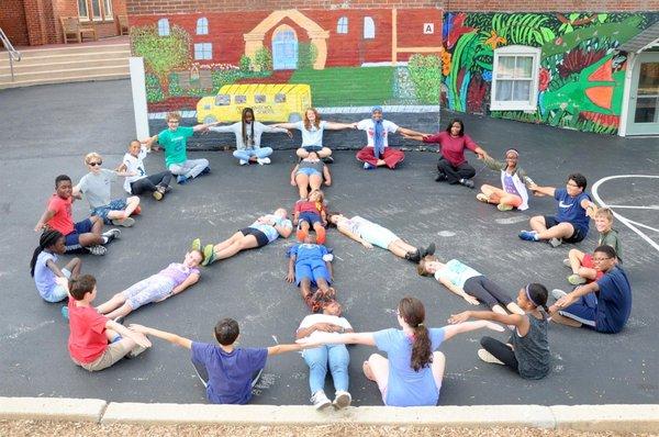 Middle school students create a peace sign for a collage to commemorate International Day of Peace.