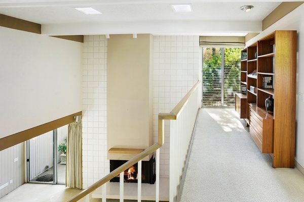 Loft study are overlooks living room and opens to a lush garden patio