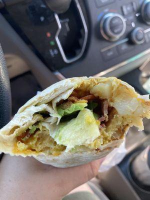 Breakfast burrito with bacon and avocado.