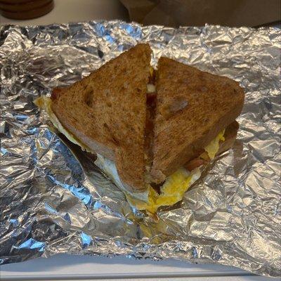 Bacon, egg and cheese breakfast sandwich on wheat bread.