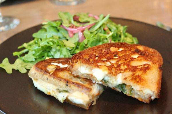 The Cheesy Grilled Cheese was made with fontina val d'aosta, goat cheese, pecorino, tomato jam, rebel bakery sourdough, arugula salad