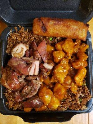 Chinese food with egg roll over fried rice