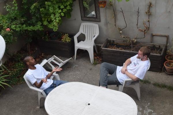 Two of the students from the trip sitting in the back of the Villa conversing in French, taught to them by Nicole Charles.