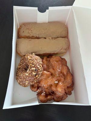 Maple bars, apple fritter, and a blueberry donut w/ crunch topping.