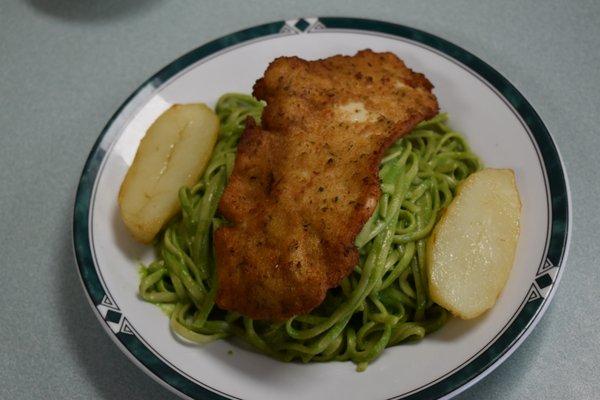 Tallarin Verde con Milanesa de Pollo- fried chicken breast lightly breaded on a bed of Peruvian pesto sauce with spaghetti