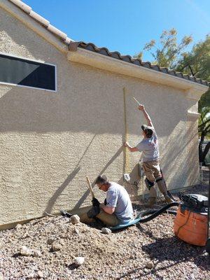 Measuring for location of downspout to vent the Radon gas.