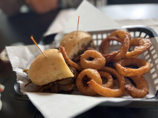 Philly cheesesteak and onion rings - house made roast beef with hand dipped onion rings, yum!