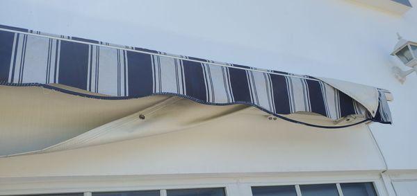 Awning fabric damage on right side.