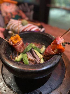 Ribeye in aguachile with avocado, cucumber, onion in fresh squeezed lime marinade. Comes with bacon wrapped cheese baby peppers tortilla r&b