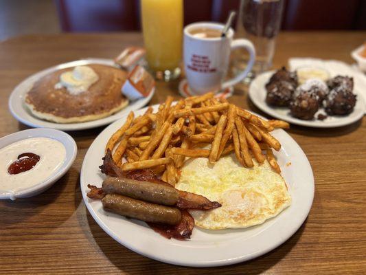 A combo with pancakes, eggs, sausage and bacon. With coffee and Orange Juice. Sub for seasoned fries.