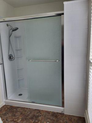 Hall Bathroom after with fixtures and shower caddy.