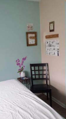 Massage table and chair in room