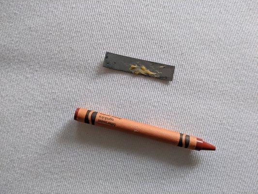 Piece of metal that was in my burrito. Crayon for size reference.