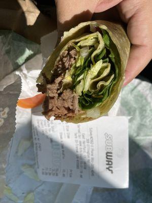 Half of my $11.26 steak wrap that tasted like lettuce.