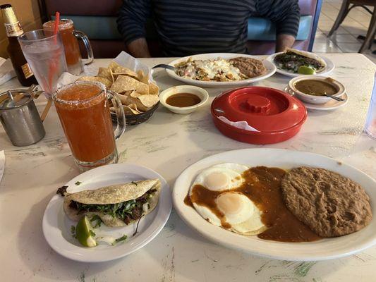 Chilaquiles, huevos rancheros, barbacoa taco and micheladas