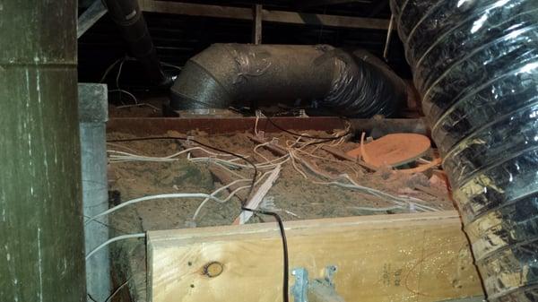 Picture of my attic after Joe Byrne's tech broke something in the attic - note the splintered wood.