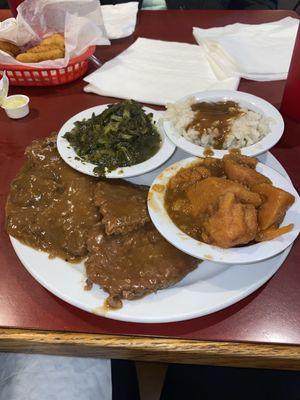 Country style steak, turnip greens, yams, and rice and gravy.