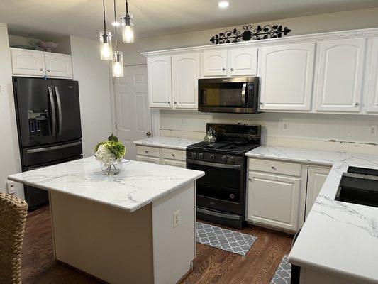 Quartz Countertop replacement. Done mind the backsplash...replacement upcoming.