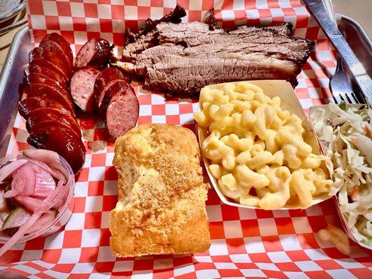 Smoked sausage, brisket, cheesy Mac, coleslaw & honey cornbread.