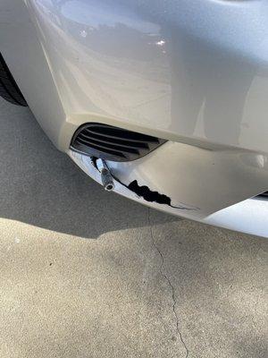 Broken bumper with debris from freeway