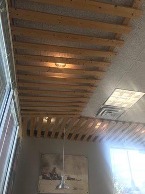 Wood pallets on the ceiling? Remodel budget must be really shot this year.