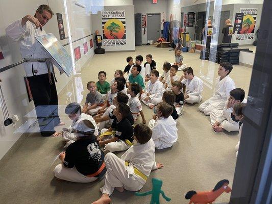 Sensei Carter teaching about the US and the US flag at the end of a class.