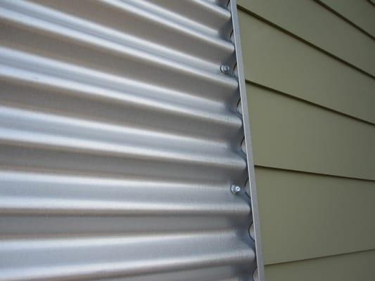 Custom corrugated metal siding with vinyl siding