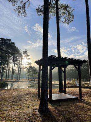 Wedding arbor on the lawn by the pond